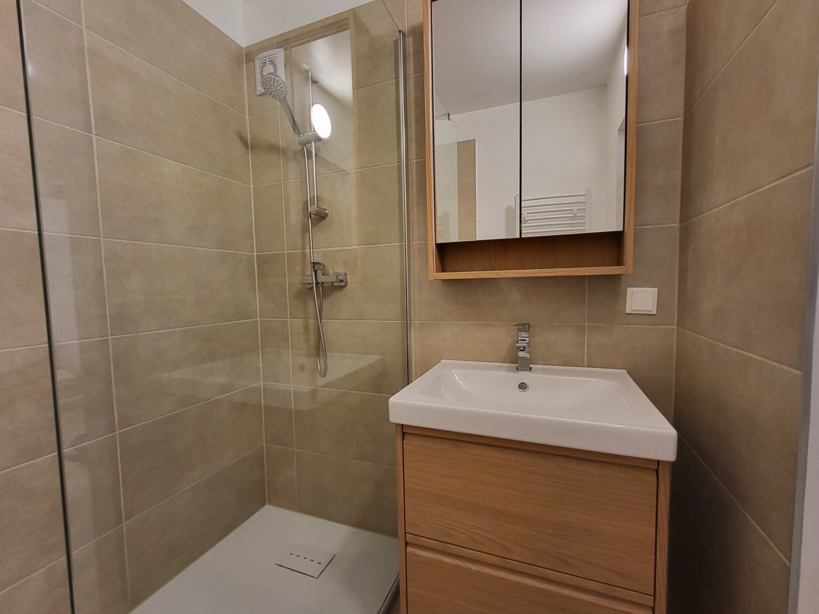 Modernes Badezimmer mit Holzmöbeln und einer Glasdusche